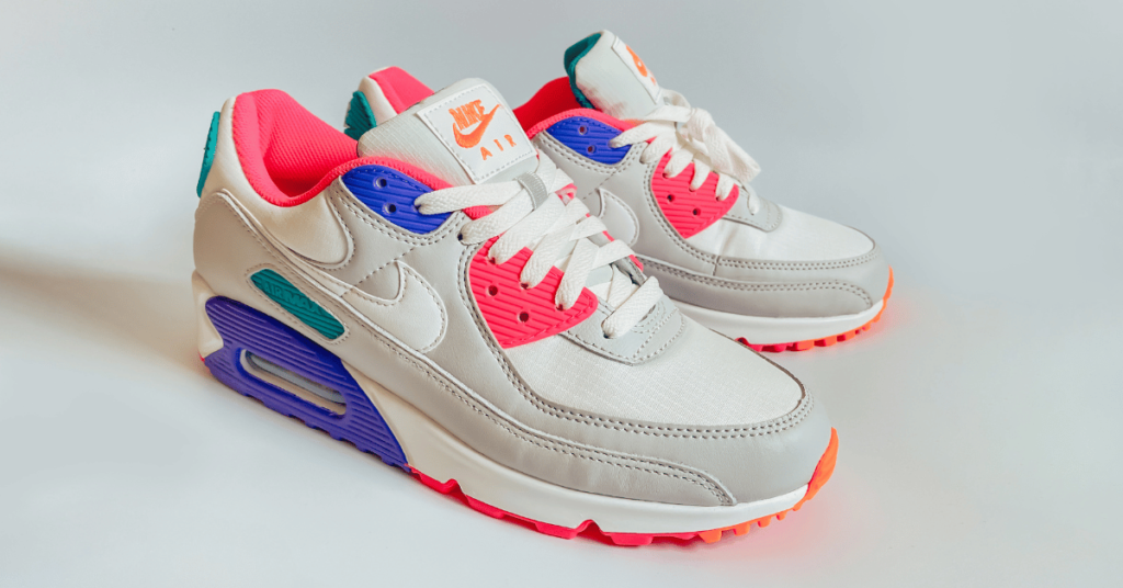 a pair of white and pink sneakers